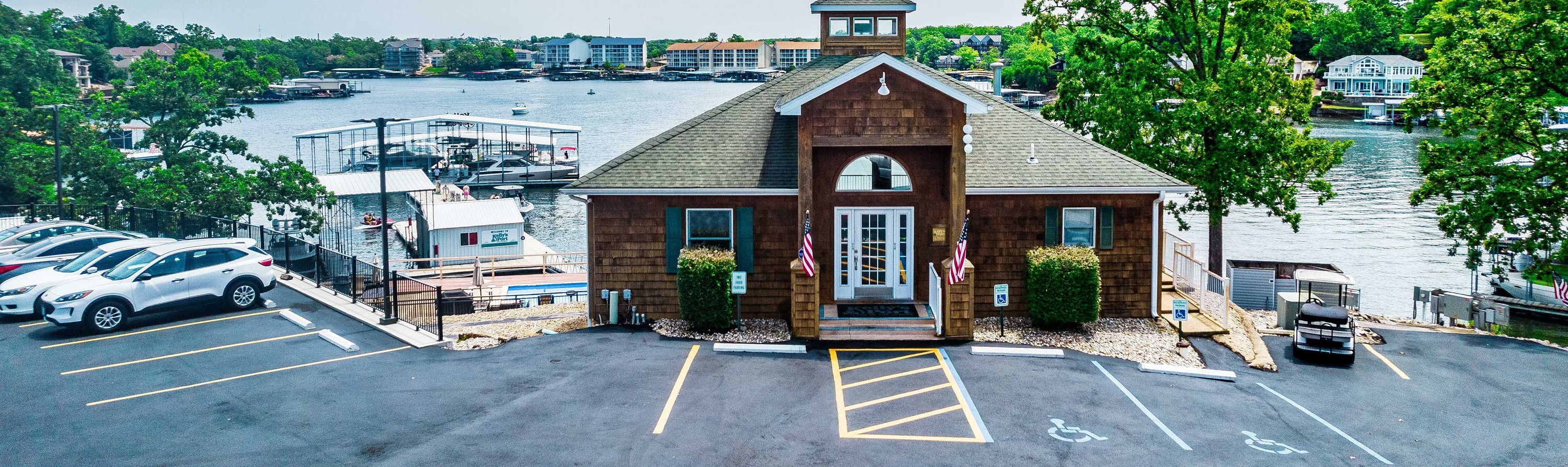 Wooden Porch of Kelly's Port dealership overlooking gas docks with boats in port